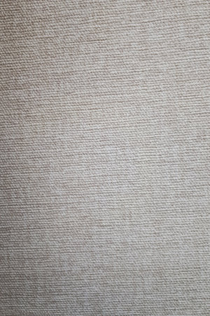 Closeup of dense linen for curtains, beige, gray color. vertical photo.