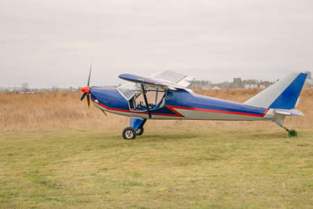 Sports plane on green field. private small plane