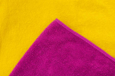 Bath towels yellow and lilac, flat lay. Horizontal photo with copy spaceの写真素材