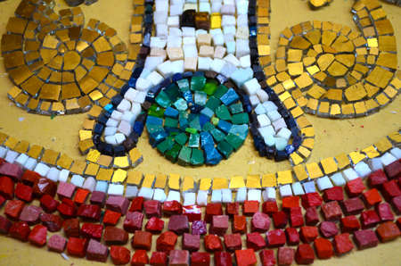 Drawing from smalt in the mosaic workshop. Making a red circle with a pattern inside. selective focus.の写真素材