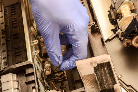 Inkjet printer repair. Workplace engineer fixes deviceの写真素材