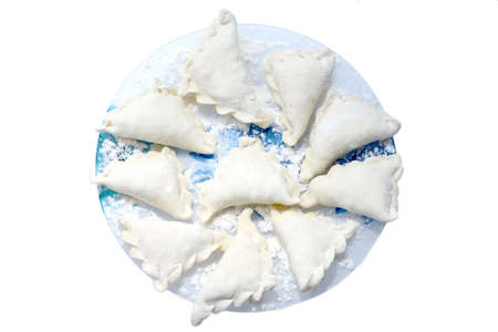 Ready-made vareniki on plates. Ukrainian national food on a white background. Lenten dish.