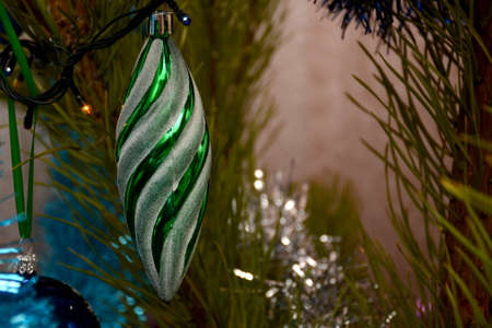 Green toy on a pine branch. New Year and Christmas holidayの写真素材