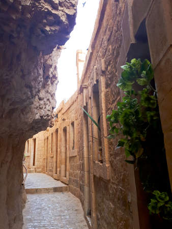 Greek Orthodox monastery in a rock on the mountain of temptations. Pilgrimage to the Holy Land, vertical photo of a corridor of cavesの写真素材