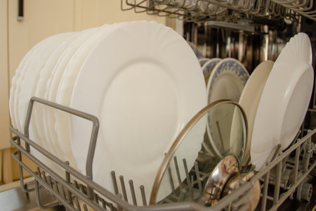 Clean dishes in new dishwasher in the kitchen. The concept of home interior and comfortの写真素材