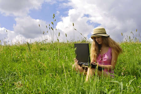 Young woman on green meadowの写真素材