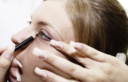 Eye - woman applying make upの写真素材