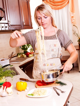 A woman cooking dinner in the kitchen. Healthy Eatingの写真素材