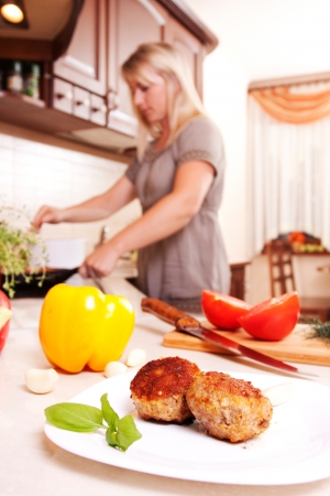 A woman cooking dinner in the kitchen  Healthy Eatingの写真素材