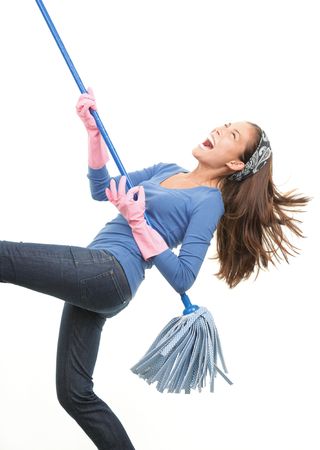Cleaning woman having fun by playing air guitar with the mop. Isolated on white background.の写真素材