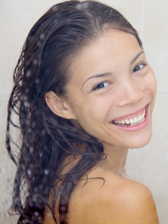 Closeup portrait of woman in shower smiling happy looking at camera  Mixed-race Asian Chinese  ...
