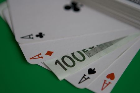 One hundred euro paper with playing cardsの写真素材