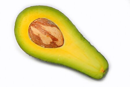 Section of avocado with stone isolated on white backgroundの写真素材
