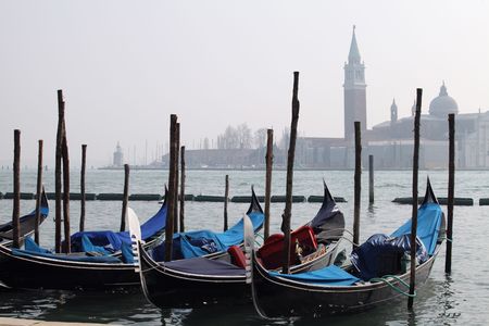 Gondolas tied up along the Grand Canal, Venice, Italy, on a cold Winter's dayの写真素材