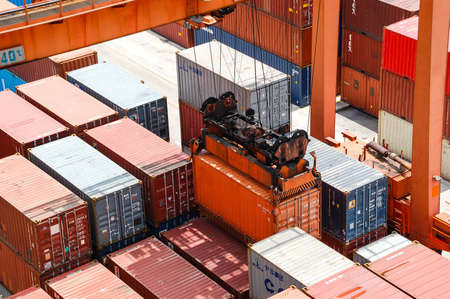 Bangkok, Thailand - Mar 14, 2006: Container Cargo freight ship with working crane bridge in shipyard...