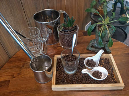 Coffee beans and cup of coffee on wooden table.の写真素材