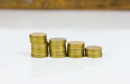 Gold coin stacks on white background.