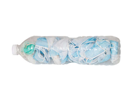 Used masks are stored in plastic water bottles to be disposed of in the trash to prevent the spread of COVID-19 isolated on white background.の写真素材