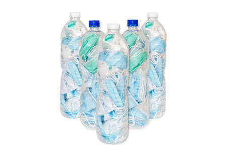 Used masks are stored in plastic water bottles to be disposed of in the trash to prevent the spread of COVID-19 isolated on white background.の写真素材