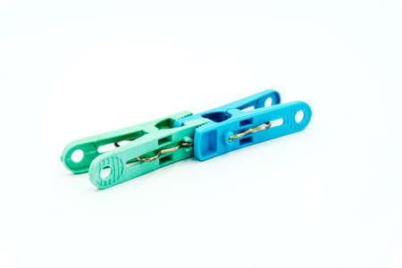 Blue and Green plastic clothespin on white background, A line of color clothespins close-up on a...
