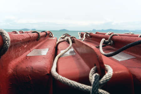Close-up knot rope tied around stake on boat or ship, boat mooring rope.