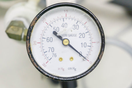 Pressure gauge on a gas regulator in a laboratory analytical equipment.