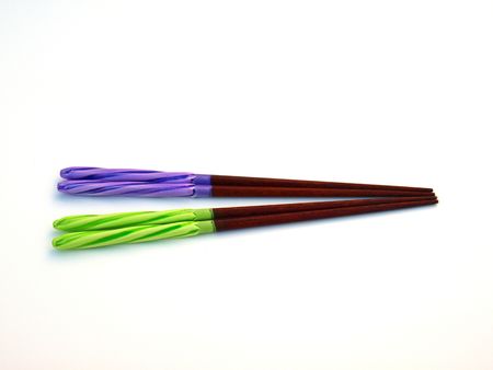 Two pairs of brightly coloured chopsticks make every meal more fun.の写真素材