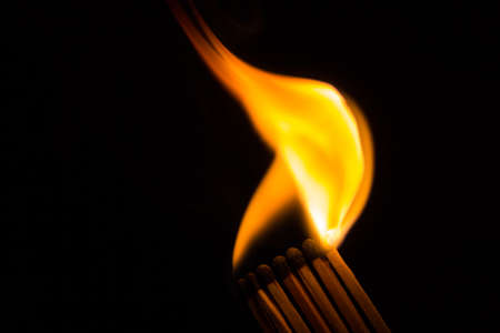 A row of matches is being ignited, spreading the fire