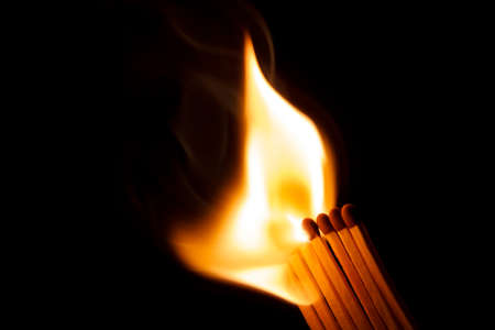 A row of matches is being ignited, spreading the fire