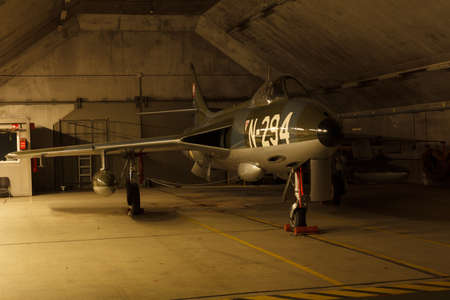 Leeuwarden, The Netherlands, Feb 6 2018: A Hawker Hunter in a dim lit shelter at air firce base...