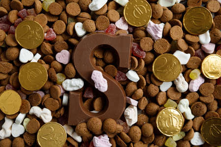 Dutch candy called Pepernoten eaten during Sinterklaas feast. The coins representing the expensive time.の写真素材