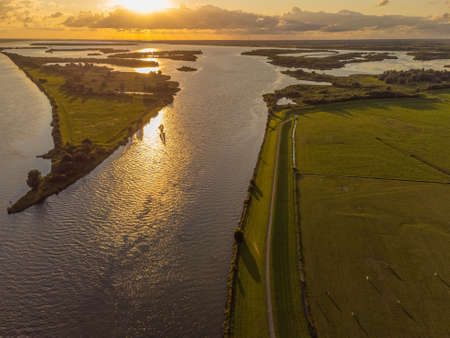 Aerial view of river IJsssel and Ketelmeer with small islands and wetlands in the late evening sunの写真素材