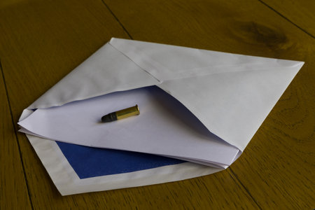An envelope with a bullet letter. Concept for extortion and threatening someone.