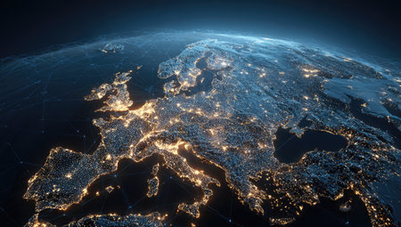 An overhead perspective displays Europe at night, highlighting urban areas with glowing lights. The image features a dark blue backdrop representing space, contrasting with the vibrant illumination of the continents. Suitable for illustrating global connectivity and digital communication, the image could be useful for various commercial and editorial projects.の素材