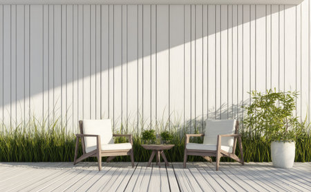 This image showcases an outdoor seating arrangement featuring two chairs and a small table. The composition is set against a white, vertically-paneled wall, with sunlight casting shadows. The scene includes green plants and a wooden deck, suggesting a modern and inviting space. Ideal for illustrating relaxation or leisure themes.の素材