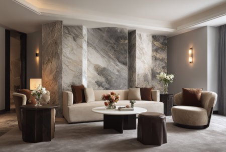 This living space features a modern interior design with a focus on neutral tones, creating a serene ambiance. The room showcases a large marble wall, providing a striking backdrop for the seating area. Natural light enhances the textures and colors, suitable for architectural, lifestyle, and design-related media.の素材