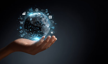 A hand gently cradles a glowing globe surrounded by digital icons on a dark backdrop. The composition features a blue and white color palette, with bright highlights suggesting digital technology. The image's concept may be suitable for illustrating topics like globalization, technology, and data visualization in various editorial and commercial contexts.の素材