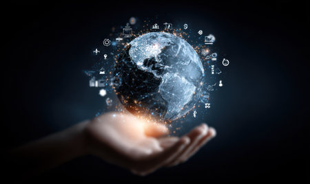 An image showcases a human hand cradling a luminous globe surrounded by digital icons. The composition features a dark background, highlighting the bright sphere with intricate details. Visuals include radiant light, high contrast, and a futuristic, technological aesthetic suitable for various commercial or editorial applications.の素材