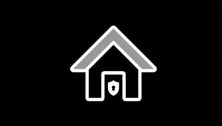 This image presents a stylized house icon, featuring a shield within its doorway, set against a dark backdrop. The composition is simple, using white and gray lines for the house and shield. The minimalist design and high contrast create a strong visual impact. The image is suitable for various applications related to security and safety.の素材