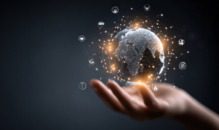A hand cradles a digital representation of the world, surrounded by glowing particles and interconnected symbols. The image features a dark background with orange and white highlights, offering a futuristic aesthetic. This conceptual illustration is suitable for diverse applications, including technology, business, or data-related projects.の素材