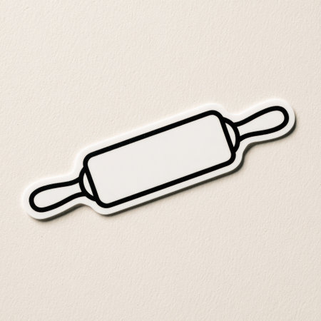 A simplified illustration depicts a rolling pin. The object is rendered in white with black outlines, creating a bold contrast. The composition is clean and minimalist, set against a plain, off-white background. This image could be used for various commercial projects related to cooking, baking, or design.の素材
