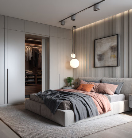 This image showcases a modern bedroom interior featuring a bed with soft bedding. The scene includes a closet, ambient lighting, and a neutral color palette. The composition has a clean, contemporary style, with potential uses in home design publications or as a backdrop for lifestyle content.の素材