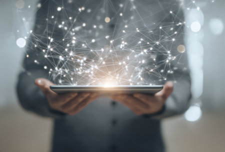 A person is holding a tablet with digital network connections, representing technology and communication. The composition features a blurred background with focus on the device. Soft lighting illuminates the scene, enhancing the modern aesthetic. Suitable for various editorial and commercial applications related to networking and digital.の素材