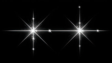 Two bright starburst shapes shine brightly against a black background. The image presents stark contrast, with sharp lines and points of light. The composition features symmetry and central focus. Suitable for diverse design projects, it could be used in various commercial or editorial contexts.の素材