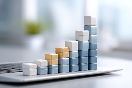A close-up view presents a graph constructed from stacked blocks. The blocks are of varying heights and colors, indicating a rising trend. The image exhibits a shallow depth of field, with soft focus in the background. It may be used for business presentations, financial reports or data visualizations.の素材
