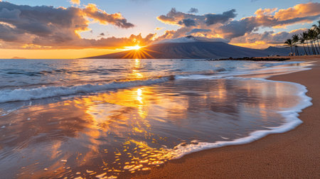A breathtaking sunset scene showcases a beach with golden sands and incoming waves. The sky is painted with fiery oranges and yellows, illuminating the ocean's surface. A mountain range provides the backdrop, enhancing the dramatic composition. Ideal for travel, tourism, or environmental related projects.の素材