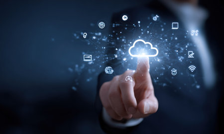 A person in professional attire touches a glowing cloud icon, surrounded by abstract digital symbols. The composition features a shallow depth of field, with soft blue and white hues. This image is suitable for various applications related to technology, business, and innovation. It can be utilized in both commercial and editorial contexts.の素材