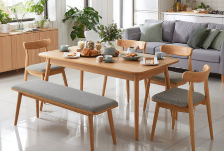 An interior shot showcases a dining room setup, featuring a wooden table surrounded by chairs and a bench. The scene is illuminated by natural light, enhancing the warm tones of the wood and the neutral colors of the furniture. This image is suitable for illustrating home decor, lifestyle, or interior design concepts, offering versatility for commercial use.の素材