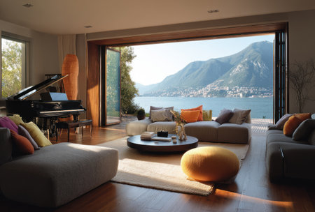 A spacious living room featuring a grand piano and large windows offering a breathtaking view of a lake and mountains. The interior showcases a contemporary design with neutral colors and modern furniture. Sunlight streams through the windows, illuminating the room and creating a warm atmosphere. Suitable for architectural, interior design, or lifestyle publications.の素材