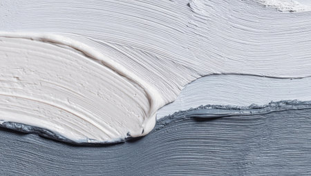 This abstract artwork showcases layered brushstrokes of varying grays and whites, creating a textured surface. The composition emphasizes the interplay of light and shadow, with visible ridges and valleys formed by the paint. The piece's overall aesthetic may suit commercial applications or editorial purposes.の素材